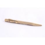 A 9CT GOLD BAKERS POINTER CALENDER PROPELLING PENCIL, it has two rotating rings at the end with