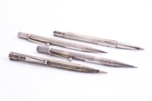 FOUR SILVER PROPELLING PENCILS, manufactured by Johnson Matthey & Co London, one dated 1946, two
