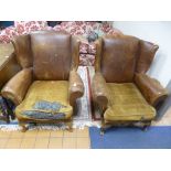 A PAIR OF LEATHER WING BACK ARMCHAIRS (in need of restoration)