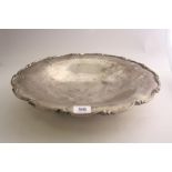 A CIRCULAR WHITE METAL BOWL, with moulded floral border set on three ball feet, stamped 800,