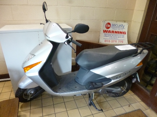 A HONDA MOPED, model SCU 100 F-S 102cc, petrol, silver paint work, Reg No BG57 AEE, current recorded