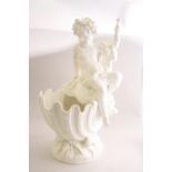 A 19TH CENTURY MINTON PARIAN WARE TABLE CENTRE MODELLED AS A PUTTI, sat a top nautilus shell with