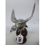 A DESMO CHROME CAR MASCOT, of an eagle on wooden stand, wing span approximately 11cm