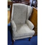 A MODERN WING BACK ARMCHAIR