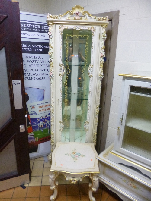 AN ITALIAN STYLE GLAZED CORNER CUPBOARD, with ornate cream and gilt detail and a similar