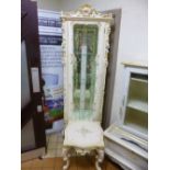 AN ITALIAN STYLE GLAZED CORNER CUPBOARD, with ornate cream and gilt detail and a similar