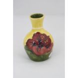 A SMALL MOORCROFT POTTERY VASE, Hibiscus pattern on yellow/green ground, impressed marks to base,