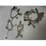 FOUR CHARM BRACELETS, all with novelty charms to each