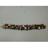 AN AGATE BRACELET, comprising of five fancy shape links with multiple coloured agate pieces