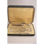 A CASED MATCHED SILVER MOUNTED SEVEN PIECE MANICURE SET