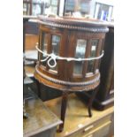 A MODERN HARDWOOD GLAZED CIRCULAR TRAY TOP DRINKS CABINET (sd)