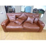 A TAN LEATHER THREE SEATER SETTEE