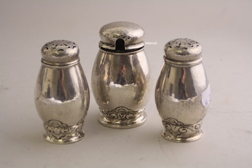 A CONTINENTAL WHITE METAL THREE PIECE CRUET, of bulbous ovoid form with scroll decoration, stamped