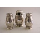 A CONTINENTAL WHITE METAL THREE PIECE CRUET, of bulbous ovoid form with scroll decoration, stamped