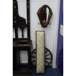 A WALL MIRROR FORMED WITHIN A 19TH CENTURY HORSE COLLAR, long footstool and a cartwheel four