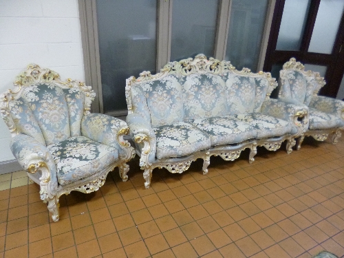 AN ITALIAN STYLE THREE PIECE SUITE, with ornate white and gilt frame, comprising of a three seater