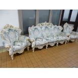 AN ITALIAN STYLE THREE PIECE SUITE, with ornate white and gilt frame, comprising of a three seater