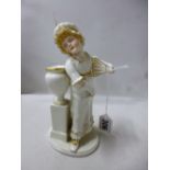 A ROYAL WORCESTER FIGURE, girl standing before urn holding fan, modelled by James Hadley in Kate