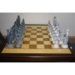 A LLADRO PORCELAIN CHESS SET, with board, thirty two pieces of Medieval design by Julio Fernadez,