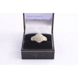 A 9CT GOLD CLUSTER RING, with single cut diamonds within a circular shape to a tapered diamond