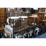 AN OAK REFECTORY STYLE DINING TABLE, and six wheel back chairs including two carvers (7)