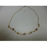 A 9CT GOLD AMETHYST NECKLACE, with flower shape detail, length 42cm, weight 73 grams, hallmarks