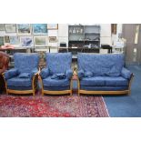 AN 'ERCOL' THREE PIECE SUITE, with blonde frame and blue upholstered loose cushions