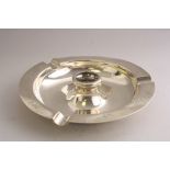 A SILVER CIRCULAR PRESENTATION ASHTRAY, with central well, three recesses to rim, five signatures,