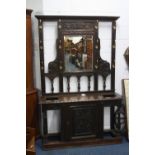 A LARGE VICTORIAN CARVED OAK MIRROR BACK HALL STAND, with central lower cupboard, approximate size