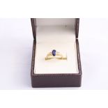 A 9CT GOLD SAPPHIRE AND DIAMOND RING, with oval shape sapphire, flanked by single cut diamonds,