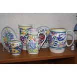 A GROUP OF POOLE POTTERY, to include 1950's jugs, one with impressed 127 and bluebird pattern, the