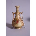 A SMALL ROYAL WORCESTER TWIN HANDLED BUD VASE, blush ivory, puce backstamp and No.1021, height 10.