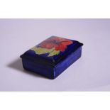 A RECTANGULAR MOORCROFT COVERED TRINKET BOX, Hibiscus pattern on blue ground, impressed marks to
