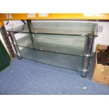 A LARGE GLASS THREE TIER TV STAND, approximate size width 110cm x depth 56cm