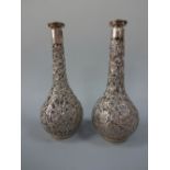 TWO SILVER MOUNTED DECANTERS, the globular bodies and long slender necks having pierced floral