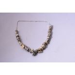 A NECKLACE, comprising mixed white metal and two tone beads