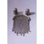 TWO SILVER THIMBLES, both with stylised floral decoration, together with chain coin purse stamped