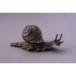 A WHITE METAL NOVELTY SNAIL, with impressed 230 or similar to underside, approximately 8.5cm long