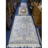 A LILAC GROUND RUG, approximate size 200cm x 122cm and two smaller pink ground rugs (3)