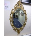 A GILT FRAMED WALL MIRROR, approximate size height 129cm x width 71cm
