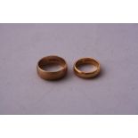 A 22CT BAND RING, together with another band ring, hallmarks for Birmingham
