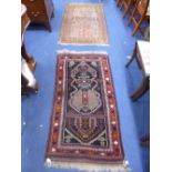 A MAROON AND BLUE GROUND RUG, approximate size 146cm x 78cm and a brown ground rug, approximate size
