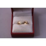A 9CT GOLD WISHBONE RING, with channel set brilliant cut diamonds, hallmarks for Birmingham, ring