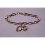 A 9CT GOLD CHARM BRACELET, fancy curb-link chain with one charm attached, hallmarks for London and