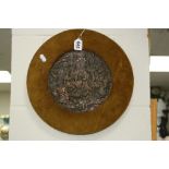 A FRAMED EMBOSSED METAL PLAQUE, depicting Mythical semi nude figures, diameter approximately 19.5cm