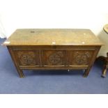 A GEORGIAN CARVED OAK TRIPLE PANEL BLANKET CHEST, on stile supports, approximate size length 115cm x