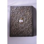 A SILVER MOUNTED PAPER FILE, the rectangular frontispiece having shaped rim to embossed scroll and