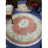 A PINK GROUND CIRCULAR RUG, approximate diameter 190cm and a fawn ground circular rug, approximate