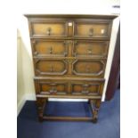 AN OAK CHEST, of two short and two long drawers on separate stand with further long drawer with