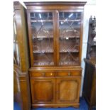 A MODERN MAHOGANY ASTRAGAL GLAZED TWO DOOR BOOKCASE, with drawers and cupboard below, approximate